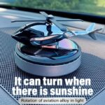 Solar-Powered Rotating Car Air Freshener with Dual Scent Blades on Dashboard